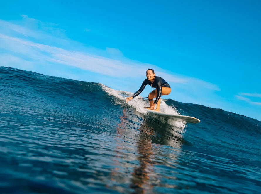 A woman participates in surf therapy.