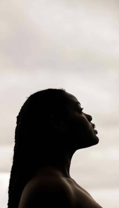 A woman looks at the sky.